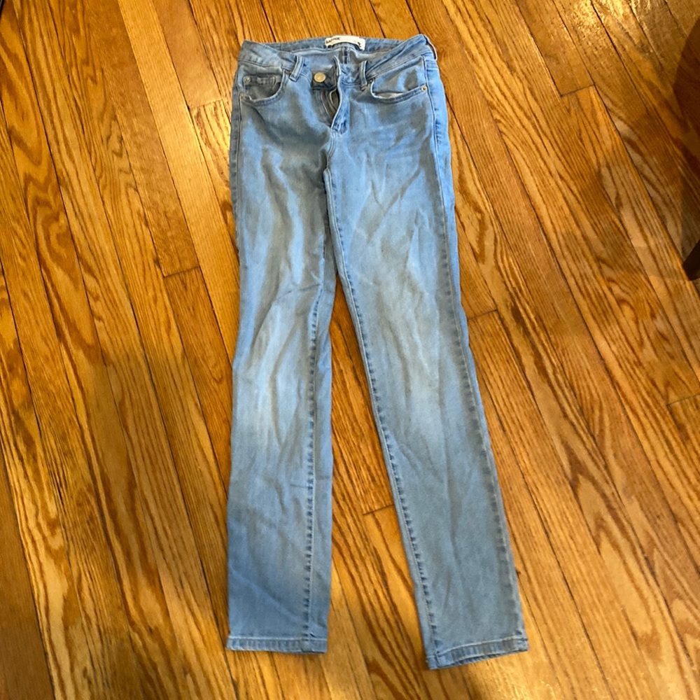 Light blue pair of “super skinny” jeans